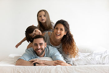 A family enjoying time together at bedtime.