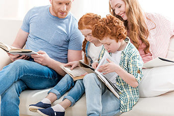 A family curled up reading together.